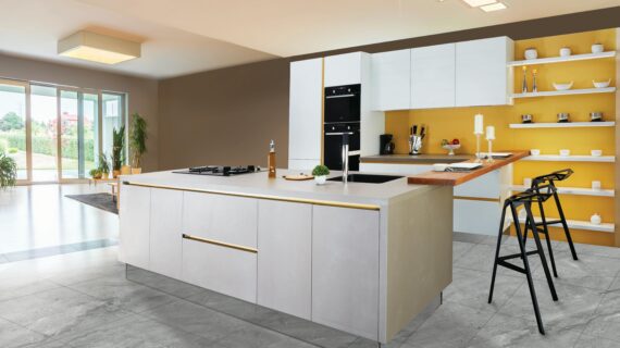 Sleek and modern kitchen interior featuring a large island and open shelving in a contemporary setting.